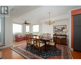 A dining room with a table set for six.