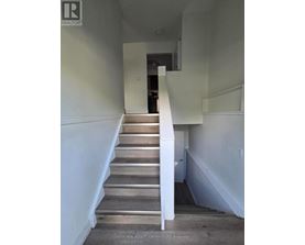 A staircase with wooden steps and white railings.