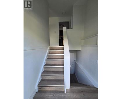 A staircase with wooden steps and white railings.