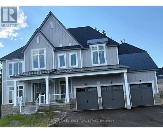A large house with a grey roof and a black garage door.