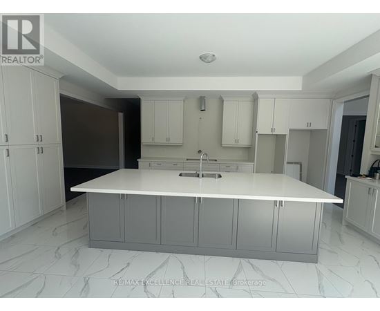 A white kitchen with a marble floor and white cabinets.