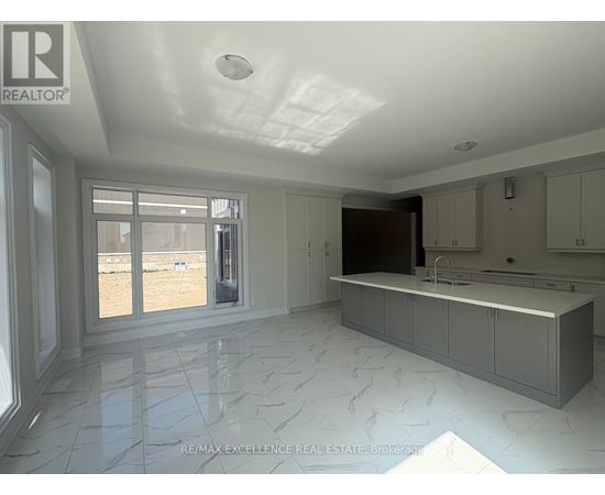 A spacious kitchen with marble flooring and a large island.