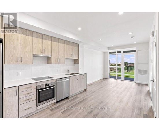 A modern kitchen with wooden cabinets and stainless steel appliances.