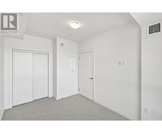 A white bedroom with a door and a window.