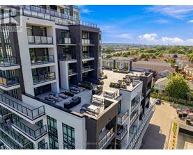 A modern apartment complex with multiple balconies and parking spaces.