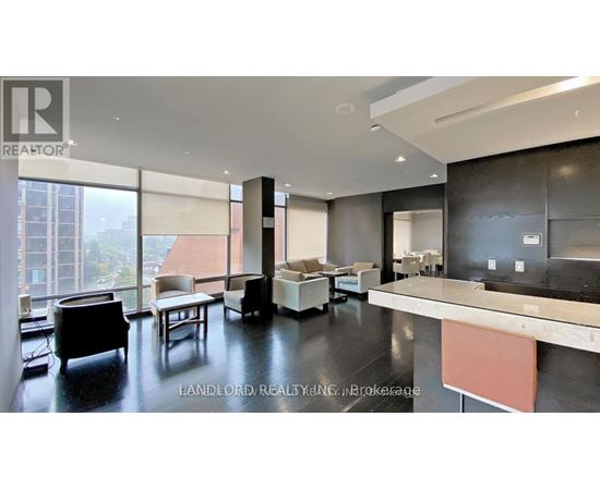 A modern living room with a large window and a view of a building outside.