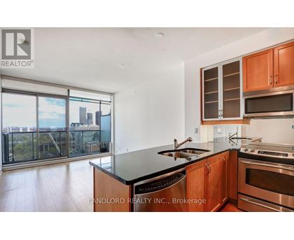 A modern kitchen with wooden cabinets and stainless steel appliances.