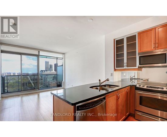 A modern kitchen with wooden cabinets and stainless steel appliances.