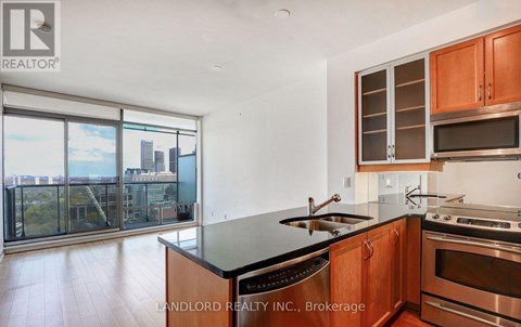 A modern kitchen with wooden cabinets and stainless steel appliances.