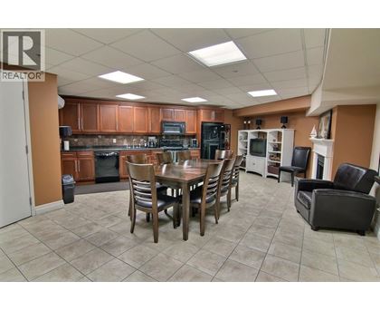 A kitchen with a table and chairs in the middle of the room.