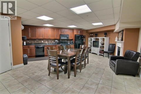 A kitchen with a table and chairs in the middle of the room.
