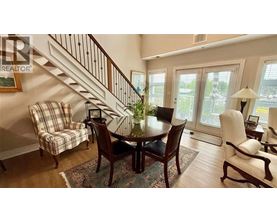 A dining room with a table set for four.