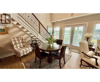 A dining room with a table set for four.