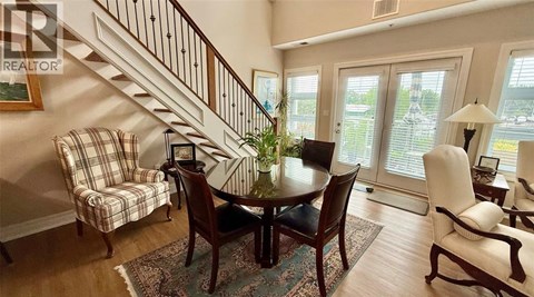 A dining room with a table set for four.