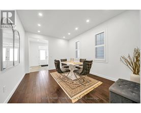 A dining room with a table set for four.