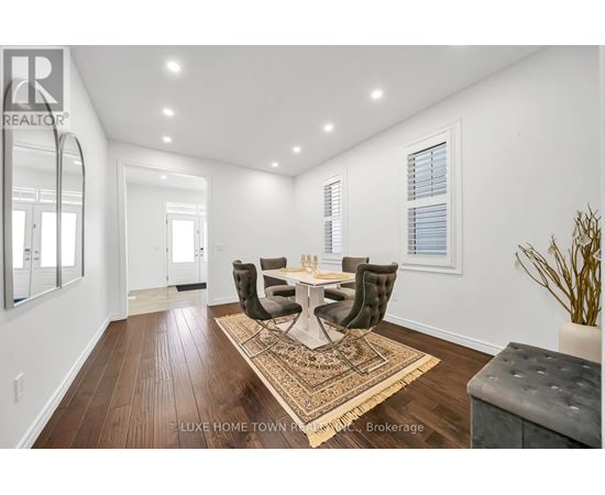 A dining room with a table set for four.