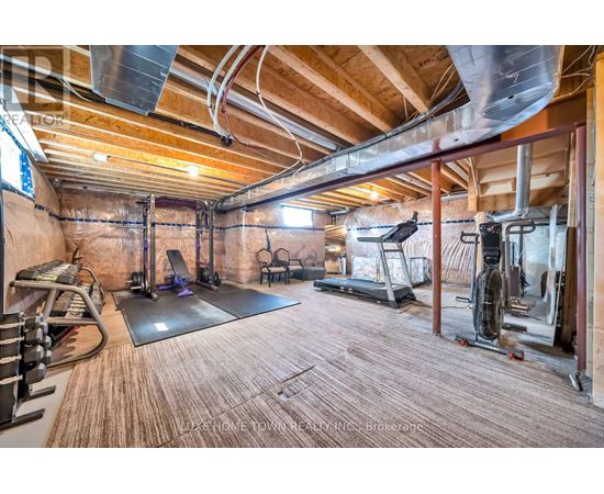 A spacious home gym with a variety of exercise equipment.