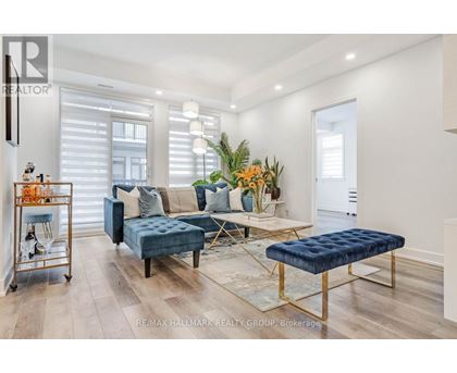 A living room with a blue couch and a gold side table.