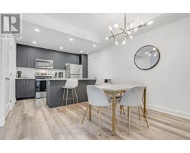 A modern kitchen with a dining table and chairs.