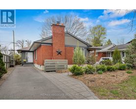 A house with a red brick chimney is for sale.