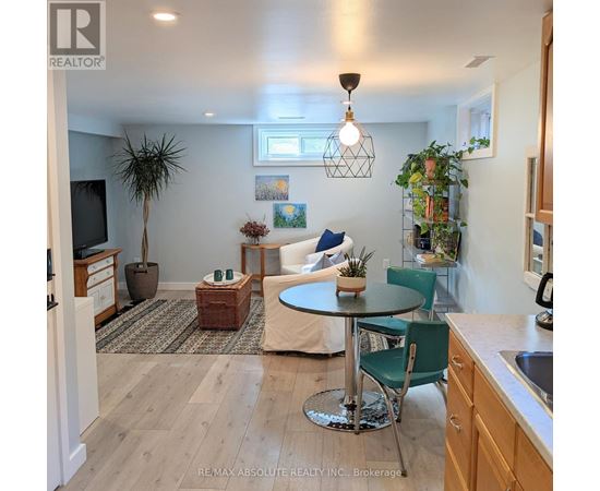 A well-lit kitchen with a dining table and chairs.