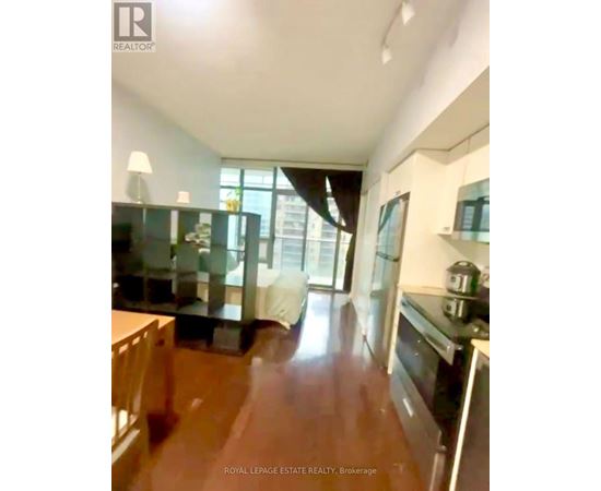 A kitchen with a stove top oven and a dining table.