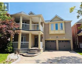A two-story house with a balcony and a garage.