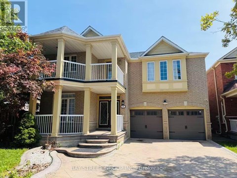 A two-story house with a balcony and a garage.