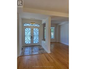 A glass door with a clock design on it.