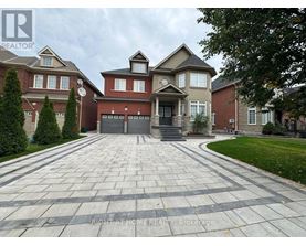 A large house with a driveway in front of it.