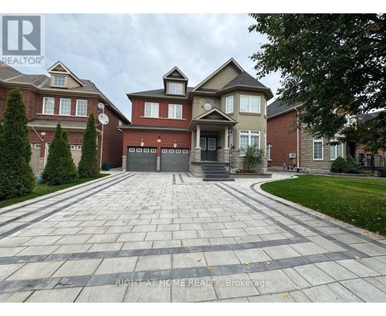 A large house with a driveway in front of it.