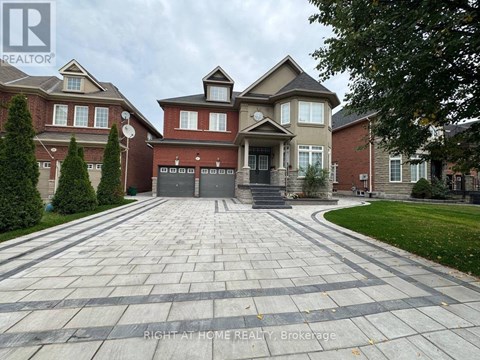 A large house with a driveway in front of it.