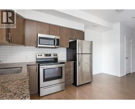 A kitchen with a stove, oven, refrigerator, and microwave.