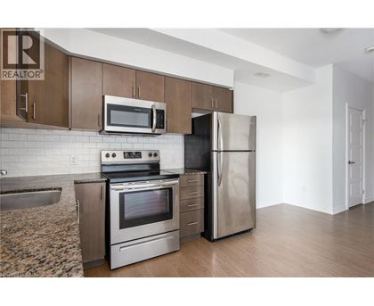 A kitchen with a stove, oven, refrigerator, and microwave.