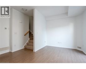 A room with a staircase leading to another room.