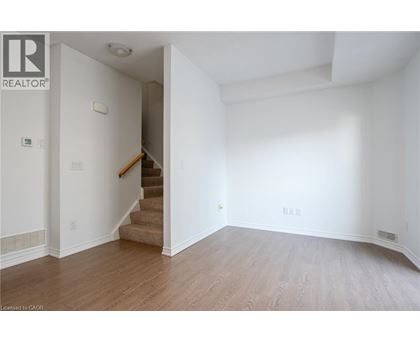 A room with a staircase leading to another room.