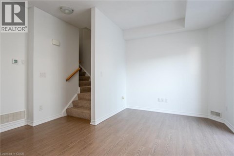 A room with a staircase leading to another room.