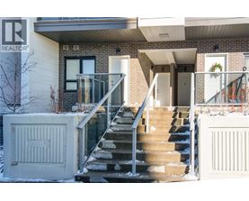 A house with a staircase leading to the front door.