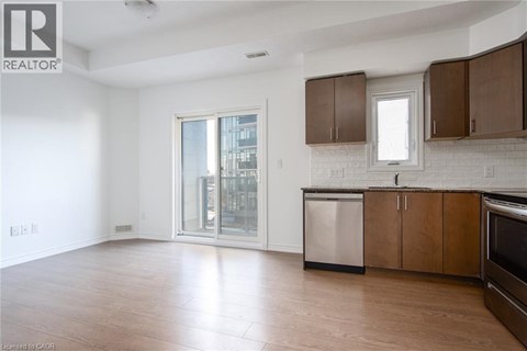 A spacious kitchen with wooden cabinets and a stainless steel dishwasher.