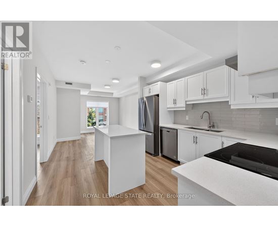 A modern kitchen with white cabinets and a black countertop.