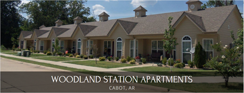 A row of houses with the text "Woodland Station Apartments Cabot, AR" in front of them.