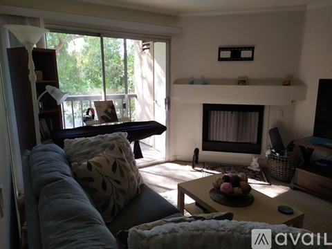 A living room with a grey couch and a coffee table.