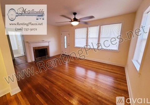 A room with a fireplace and a ceiling fan.