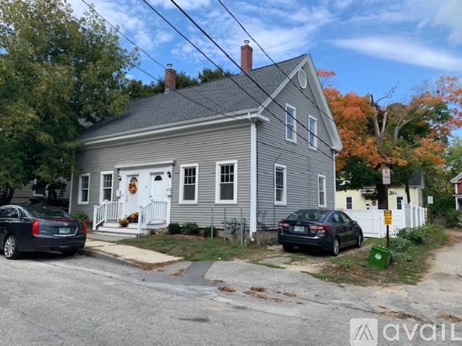 A two-story house with a white door and a garage.