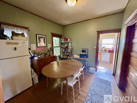 A kitchen with a table and chairs in the middle of the room.