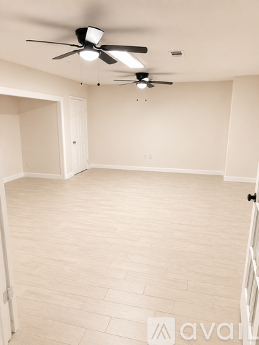 A room with a ceiling fan and light fixture.