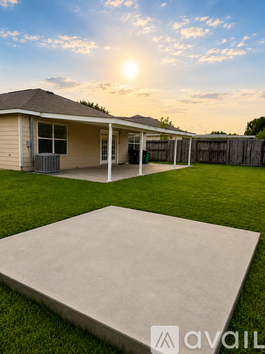 A house with a patio and a concrete slab in the foreground.