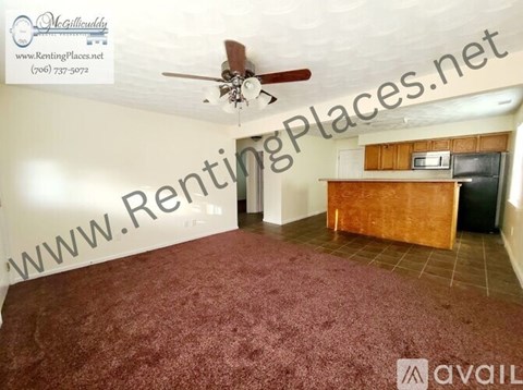 A room with a ceiling fan and a carpeted floor.