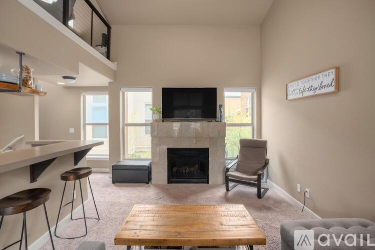 A living room with a fireplace and a television.