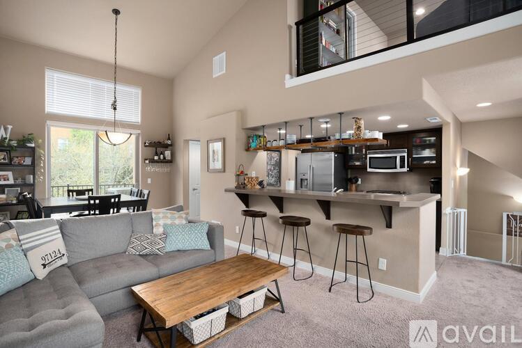 A living room with a grey couch and a wooden coffee table.
